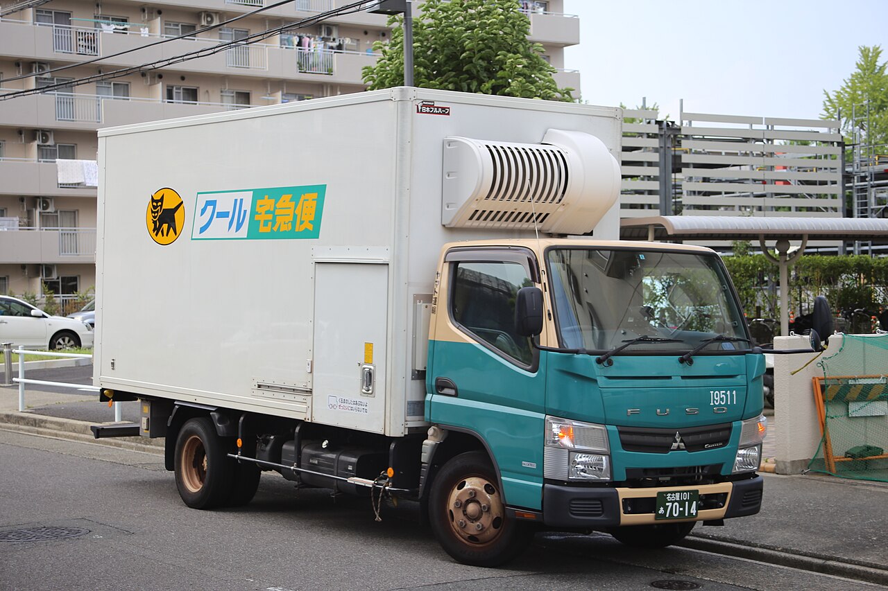 A Kuroneko Yamato Cool Takkyubin truck parked on a street in Nagoya — chilled and frozen parcels travel in these.